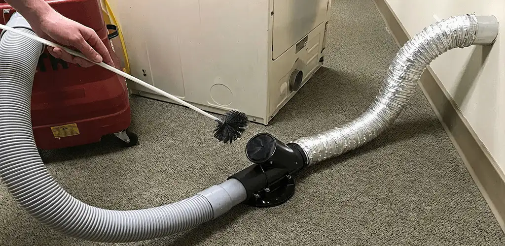Dryer vent cleaning service removing lint from a dryer duct connection in Chula Vista, CA