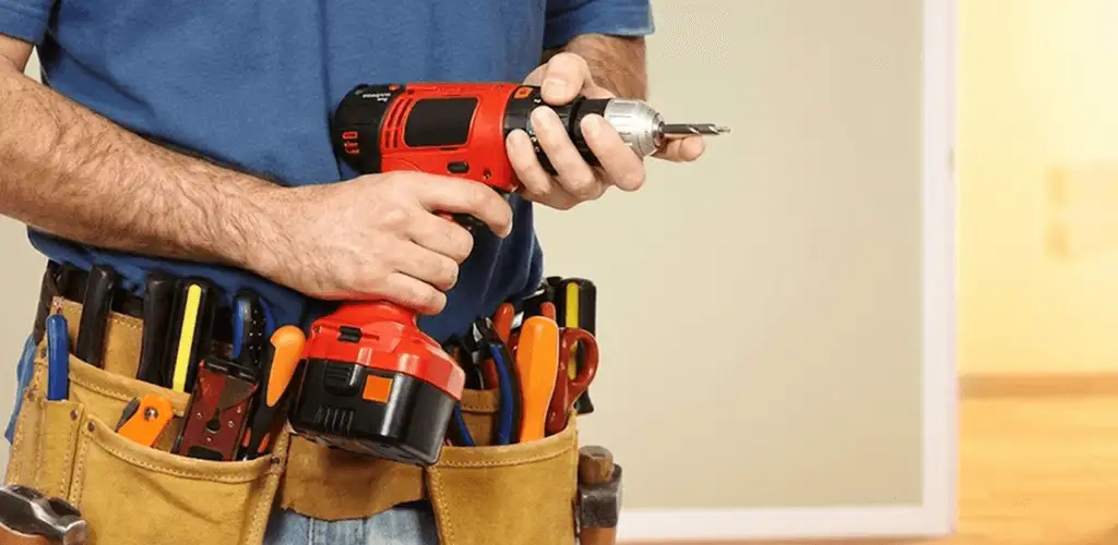 Handyman holding a power drill for home repairs and installations in Chula Vista, CA