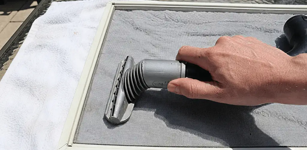 Window screen repair cleaning and fixing a damaged screen mesh in Chula Vista, CA